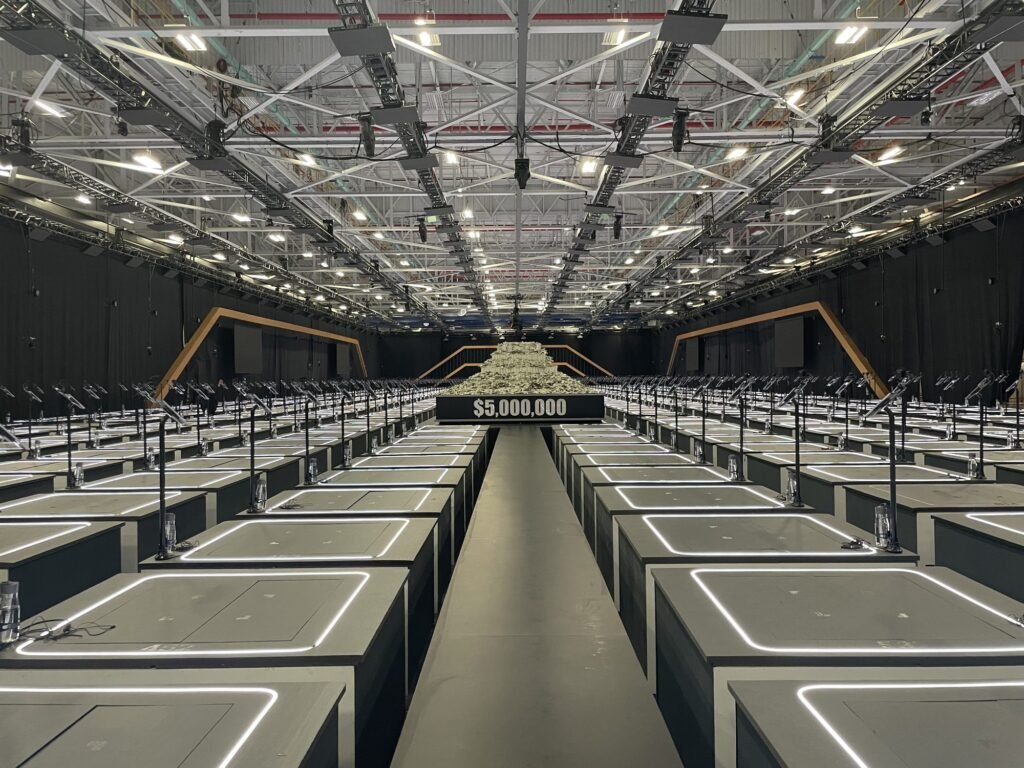 A large production set with long rows of contestant stations