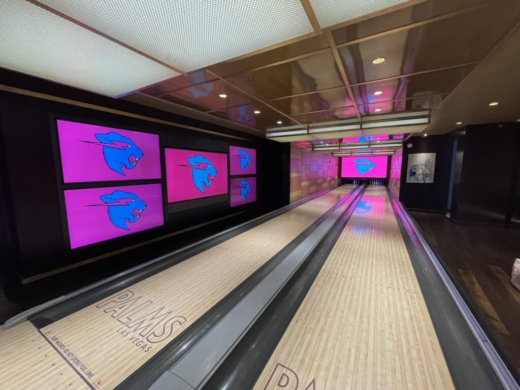 A custom-built bowling alley set with branded screens
