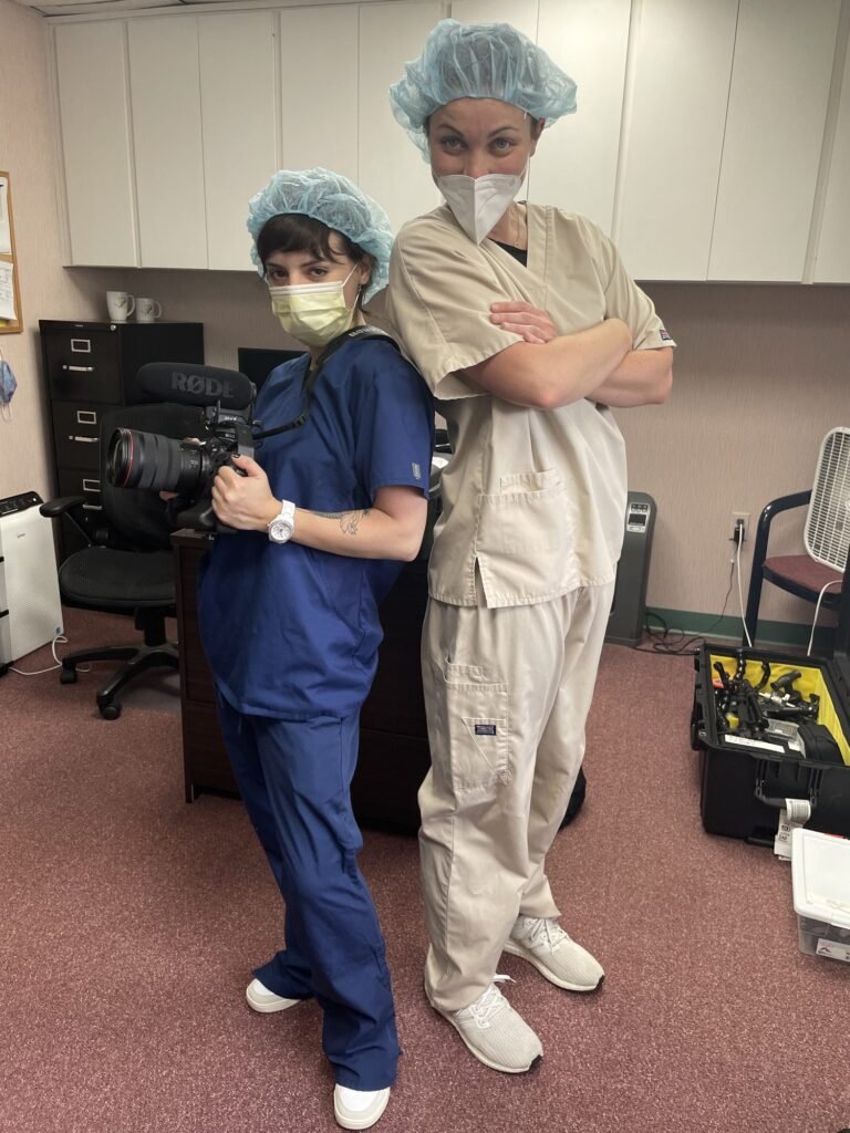 McKenzie and a colleague in medical scrubs on a themed shoot
