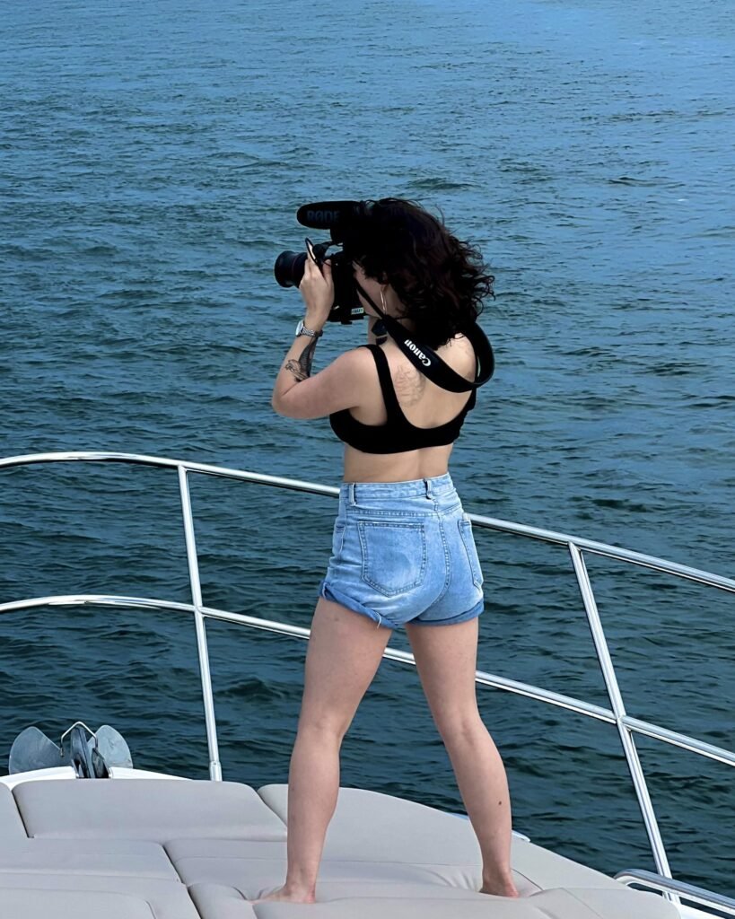 McKenzie filming from the bow of a boat