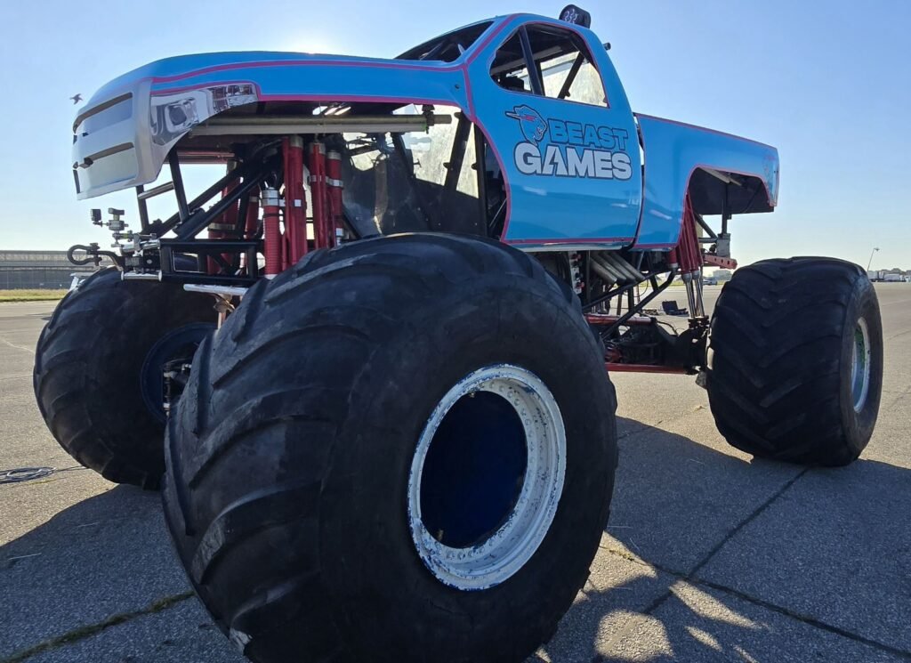 A branded monster truck staged on an airfield for a shoot